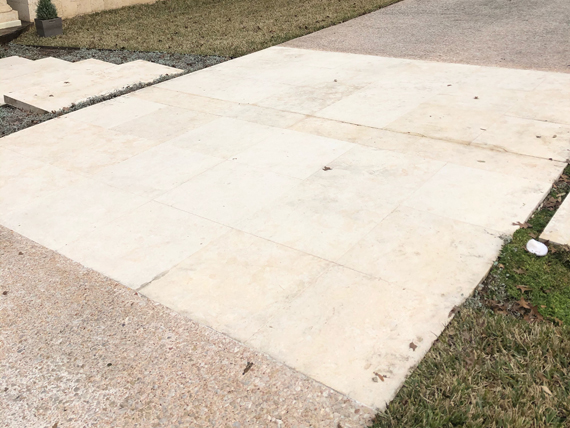After a number of cleaning steps, the driveway looks almost new.