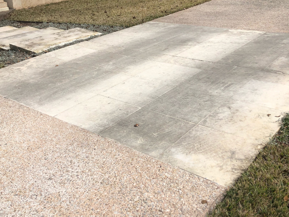 This is a limestone driveway discolored by years of mold, soil, and tread.