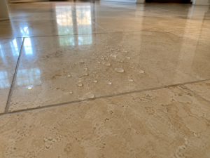 Water beading on a professionally sealed limestone floor in Austin TX
